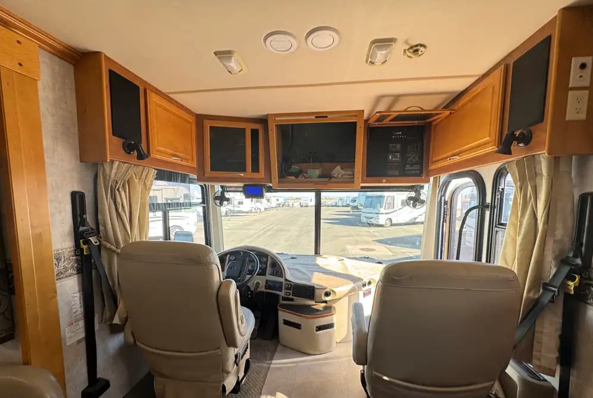 2005 Fleetwood Discovery 39L — cockpit with overhead cabinet and new TV