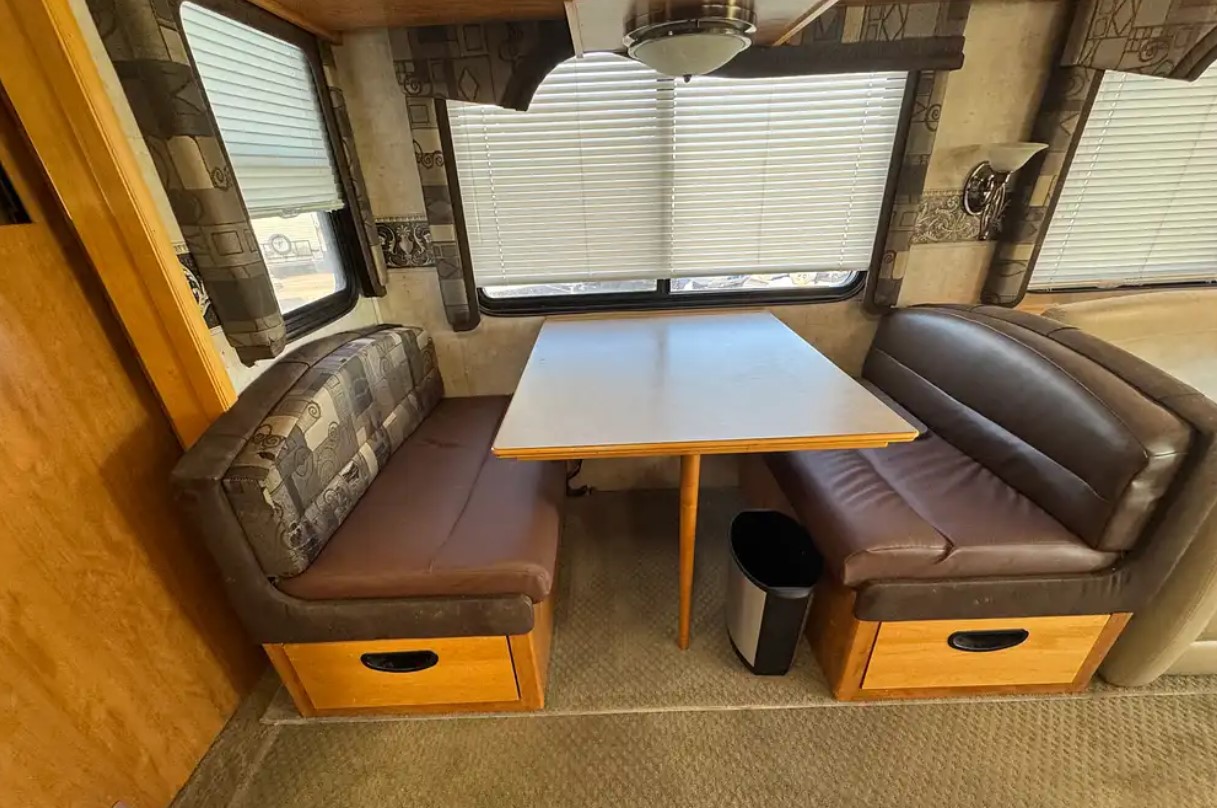 2005 Fleetwood Discovery 39L — booth dinette in the slide-out with storage under seats