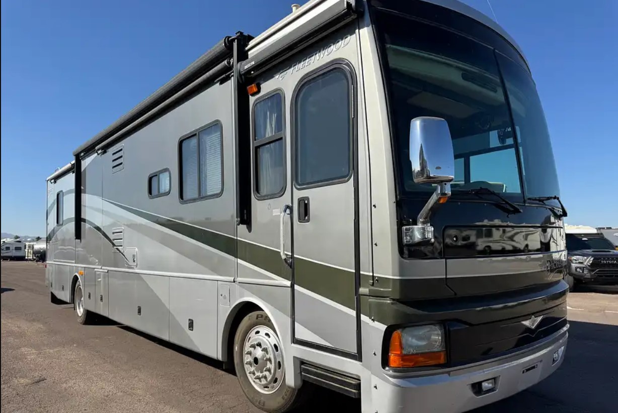 2005 Fleetwood Discovery 39L — front passenger three-quarter view with slide-outs
